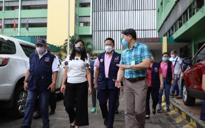 <p><strong>COVID CHECK.</strong> Quezon City Mayor Joy Belmonte and Health Secretary Francisco Duque III (2nd and 3rd from left) inspect the East Avenue Medical Center on Thursday (March 18, 2021). They also visited a market to check if minimum health safety protocols were being followed. <em>(Photo grabbed from QC government FB page)</em></p>