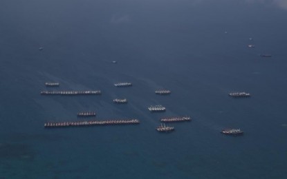 <p><strong>MARITIME PATROL.</strong> Vessels believed to be manned by Chinese maritime militia are seen off the Julian Felipe Reef in the West Philippine Sea based on information from the maritime patrol conducted by the AFP Western Command on Monday (March 22, 2021). The Julian Felipe Reef is a large boomerang-shaped shallow coral reef at the northeast of Pagkakaisa Banks and Reefs (Union Reefs), located approximately 175 nautical miles west of Bataraza, Palawan. <em>(Photo courtesy of AFP)</em></p>