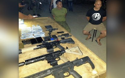 <p><strong>GUN SMUGGLING.</strong> Police and military operatives arrest Tuesday (March 23, 2021) Capt. Christopher Galvez Eslava (right) and Cpl. Laure Larot in an intelligence-driven entrapment operation for gun smuggling in Ipil, Zamboanga Sibugay province. The pair yielded various firearms and other pieces of evidence. <em>(Photo courtesy of Police Regional Office-9 Public Information Office)</em></p>