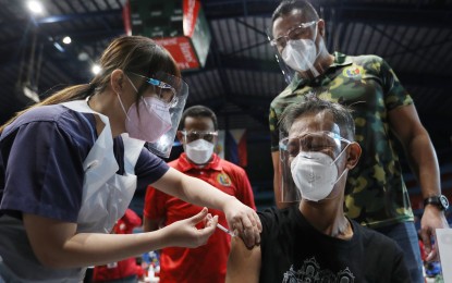 <p><strong>FIRST DOSE.</strong> A man receives his first dose of a Covid-19 vaccine in San Juan City. A health official said herd immunity could not be achieved in the country anytime soon as it is highly dependent on the supplies of Covid-19 vaccines. <em>(PNA photo by Joey Razon)</em></p>