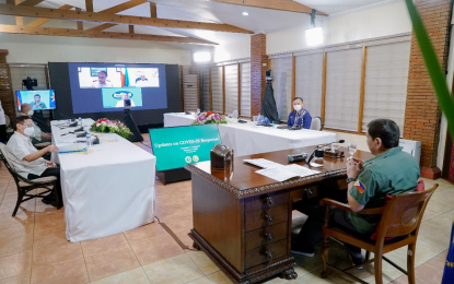 <p><strong>MEETING WITH IATF-EID.</strong> President Rodrigo Roa Duterte presides over a weekly meeting with the Inter-Agency Task Force on the Emerging Infectious Diseases (IATF-EID) core members prior to his talk to the people at the Malago Clubhouse in Malacañang Park, Manila on March 22, 2021. Some members attended the meeting via online.<em> (Presidential photo by King Rodriguez)</em></p>