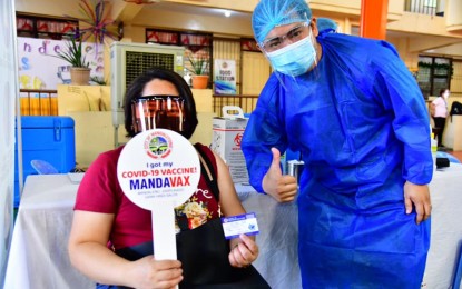 <p><strong>VACCINE PRIORITIES.</strong> A front-liner in Mandaluyong City and her healthcare worker pose for posterity after receiving her first shot of the AstraZeneca vaccine on Thursday (March 25, 2021). Some 4,000 healthcare workers in Mandaluyong City have already been vaccinated. <em>(Photo courtesy of Mayor Menchie Abalos)</em></p>