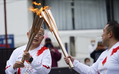 <p><strong>OLYMPIC TORCH.</strong> Olympic Torchbearer Hiroguchi Takao receives the flame in Iwaki City on day-1 during the Olympic Flame torch relay in Iwaki, Fukushima Prefecture, Japan on March 25, 2021. Following the postpone of the Tokyo 2020 Olympic Games to 2021 from July 21st to August 2nd due to the pandemic of the Covid-19, the Olympic torch will traverse all 47 Prefectures across Japan over 121 days from the J-Village National Training Centre in Fukushima Prefecture until Arriving at the Tokyo Metropolitan Government Building on July 23. <em>(David Mareuil - Anadolu Agency)</em></p>