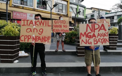 <p><strong>YES TO PEACE</strong>. Volunteers parade with their placards at the central business district of Baguio City on Monday evening (March 29, 2021) denouncing the presence of the New People's Army (NPA) communist group in some of the city's villages. The volunteers held a short program at the Melvin Jones Grandstand and lighted candles for peace. (<em>PNA photo by Liza T. Agoot</em>) </p>