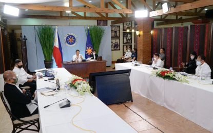 <p><strong>COVID-19 VAX</strong>. President Rodrigo Roa Duterte presides over a meeting with the Inter-Agency Task Force on the Emerging Infectious Diseases (IATF-EID) core members prior to his talk to the people at the Malago Clubhouse in Malacañang Park, Manila on Monday night (March 29, 2021). Duterte on Monday said he has ordered vaccine czar Carlito Galvez Jr. to sign any document that will allow the private sector to import Covid-19 vaccines at will. <em>(Presidential photo by King Rodriguez)</em></p>