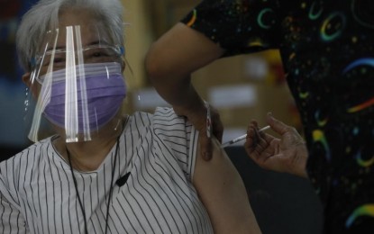 <p><strong>PROTECTED.</strong> A senior citizen receives her Covid-19 vaccine shot. As of May 10, the country has administered a total of 2,409,235 vaccine shots, more than two months after it started its vaccination campaign.<em> (PNA photo by Avito C. Dalan)</em></p>