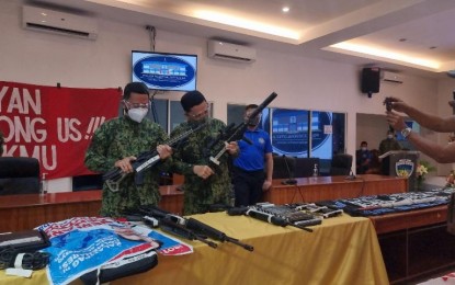 <p><strong>ARMS CACHE</strong>. Criminal Investigation and Detection Group (CIDG) chief, Maj. Gen. Albert Ignatius Ferro (right), inspects one of the several assorted high-powered firearms seized from the house of a female labor organizer, Maritess Santos David alias "Teacher Laly", in Sta. Rosa, Laguna on March 30. (<em>CIDG photo</em>)</p>