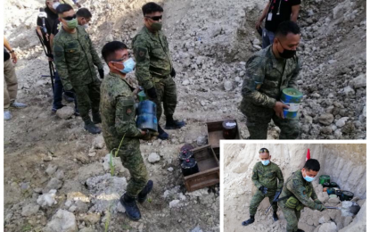 <p><strong>EXPLOSIVES</strong>. Members of the Army’s 39th Infantry Battalion’s Explosive Ordnance Disposal Team carefully carried to a hole the improvised explosive devices recovered by government troopers in various operations in Makilala, North Cotabato in recent months. The IEDs were buried with rocks and soil (inset) at a quarry site at remote Barangay Sinkatulan in the municipality on Wednesday (April 7, 2021) before it was destroyed through the use of an IED disruptor. <em>(Photos courtesy of 39IB)</em></p>