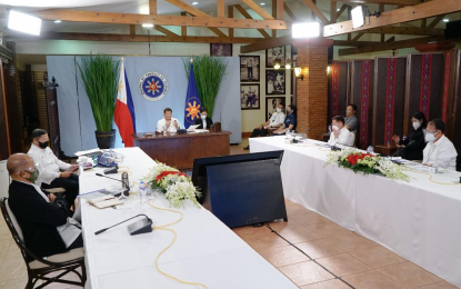 <p><strong>PUBLIC ADDRESS RESET</strong>. President Rodrigo Roa Duterte presides over a meeting with the Inter-Agency Task Force for the Management of Emerging Infectious Diseases core members prior to his talk to the people at the Malago Clubhouse in Malacañang Park, Manila on March 29. Presidential Spokesperson Harry Roque on Wednesday (April 7, 2021) said spike in the Covid-19 cases has prompted Duterte to postpone his scheduled public address. <em>(Presidential photo by King Rodriguez)</em></p>