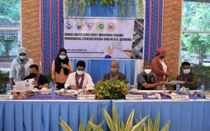 <p><strong>DONE DEAL.</strong> Lt. Gen. Corleto Vinluan Jr. (center), Western Mindanao Command chief, leads the signing of a Memorandum of Understanding that launched the Small Arms and Light Weapons program on Thursday (April 8, 2021) in Isabela City, Basilan. The program aims to minimize, if not eradicate, the loose firearms problem in the province.<em> (Photo courtesy of Westmincom-PIO)</em></p>