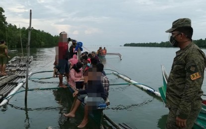 <p><strong>INTERCEPTED.</strong> The 74th Infantry Battalion intercepts 21 individuals from Sitio Limbaguhan, Tungawan, Zamboanga City on Thursday (April 8, 2021) at the Bucana Patrol Base in Barangay Tictapul due to lack of documents. Saliva-based reverse transcription-polymerase chain reaction tests are now allowed for interzonal and intrazonal travels in the city.<em> (Photo courtesy of 74IB)</em></p>