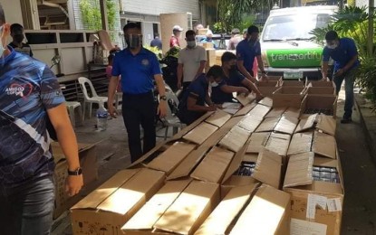 <p><strong>ENTRAPMENT.</strong> CIDG personnel inspect boxes of Covid-19 test kits in an entrapment in Barangay South Triangle, Quezon City on Tuesday (April 13, 2021). CIDG director, Maj. Gen. Albert Ignatius Ferro said the suspects failed to show the operatives their license to operate or special permits to sell and distribute the test kits. <em>(Photo courtesy of CIDG)</em></p>