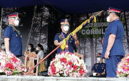 <p><strong>TURN-OVER</strong>. Police Lt. Gen. Israel Ephraim Dickson (center), chief of the Directorate for Integrated Police Operations (DIPO) northern Luzon, facilitates the turn-over of leadership of the Police Regional Office Cordillera from BGen. R’win Pagkalinawan (left) to BGen. Ronald Oliver Lee (right) on Monday (April 12, 2021) at the grandstand in Camp Dangwa, La Trinidad, Benguet. Dickson, who also served as PROCor chief, urged Lee to do his best in pursuing their mandate. (<em>PNA photo by Liza T. Agoot</em>) </p>