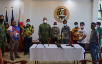 <p><strong>SURRENDER.</strong> The six gunmen who surrendered to PRO-BARMM Director Brig. Gen. Eden Ugale (center) during simple rites held Tuesday morning (April 13, 2021) at Camp SK Pendatun in Parang, Maguindanao. The surrenderers also yielded one Garand rifle, an improvised shotgun, a homemade .50-caliber Barret sniper rifle, and ammunition.<em> (Photo courtesy of PRO-BARMM)</em></p>