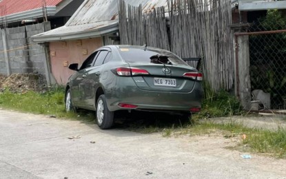 <p><strong>AMBUSHED.</strong> The bullet-riddled car of three ambush victims slumped at a roadside in Barangay Rosary Heights 11, Cotabato City, following an ambush Tuesday morning (April 13, 2021). Initial police investigation indicated that personal grudge could have triggered the incident. <em>(Photo courtesy of Daemon Lauban – Brigada News FM Cotabato)</em></p>