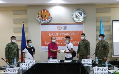 <p><strong>AID TO FORMER REBELS.</strong> Surigao del Norte Gov. Francisco T. Matugas (3rd from left) and the Army's 901st Infantry Brigade commander, Brig. Gen. George Banzon (2nd from right), lead the distribution of over PHP2 million financial assistance to 11 former rebels on Wednesday (April 14, 2021) at the Provincial Capitol of Surigao del Norte in Surigao City. The officials also called on the remaining rebels in the hinterlands to return to the fold of the law. <em>(Photo courtesy of 901 Brigade)</em></p>