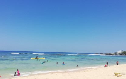 <p><strong>TOURISM</strong>. Tourists flock to the white sand beach of Patar in Bolinao town, Pangasinan during the Holy Week in this undated photo. The workers in the town who have lost income due to the pandemic were among the recipients of cash assistance from the national government. <em>(Photo by Hilda Austria)</em></p>