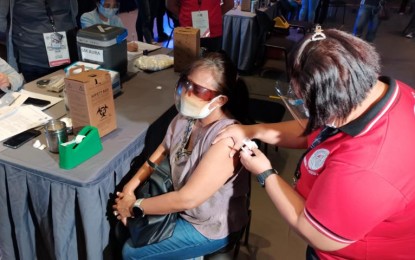 <p><strong>GET VACCINATED.</strong> A health worker administers a Sinovac jab to an elderly woman at the vaccination site in SM Aura, Taguig City on Wednesday (April 14, 2021). Senior citizens are among the first to get Covid-19 vaccines based on the government's vaccination priority listing. <em>(PNA photo by Lloyd Caliwan)</em></p>