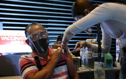 <p><strong>MEGA-VACCINATION HUB.</strong> A senior citizen gets his first shot at Taguig’s newly opened mega-vaccination hub at SM Aura in Bonifacio Global City on Friday (April 16, 2021). The site targets to inoculate 1,000 daily. <em>(PNA photo by Joey Razon)</em></p>