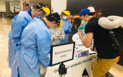 <p><strong>ASSISTING OFWs</strong>. An overseas Filipino Worker (OFW), in this undated photo, submits his documents for processing upon arrival at the Mactan-Cebu International Airport as part of the strict precautionary measures set in place by the government amid the pandemic. An ordinance was submitted to the Cebu City Council on April 15, 2021, calling for the creation of an OFW Desk.<em> (Photo courtesy of OCD-7)</em></p>