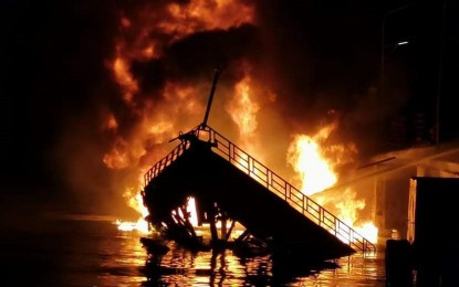 <p><strong>FIRE.</strong> M/L Saidamae, which is loaded with 150 drums of fuel, slowly sinks after it catches fire Friday evening (April 16, 2021) while moored at a private wharf in Barangay Baliwasan, Zamboanga City. Two crewmen died while three others were hurt during the incident. <em>(Contributed photo)</em></p>