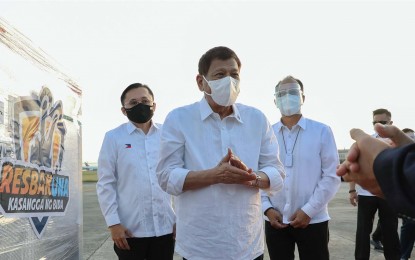 <p><strong>MORE SUPPLIES.</strong> Vaccine czar Secretary Carlito Galvez Jr. (right) accompanies President Rodrigo Duterte and Senator Bong Go during the arrival of CoronaVac jabs at Villamor Air Base, Pasay City on March 29, 2021. Galvez said agreements with five pharmaceutical companies have been finalized. <em>(Photo courtesy of PCOO)</em></p>