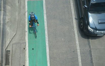 <p><strong>SAFE LANE.</strong> A cyclist utilizes the green-painted lane along Edsa, Quezon City on Monday (April 19, 2021). The painted bike lane makes them more visible to motorists. <em>(PNA photo by Robert Oswald P. Alfiler)</em></p>