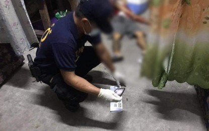 <p><strong>CRIME SCENE</strong>. An operative of the Bulacan Scene of the Crime Operation processes the crime scene where two drug suspects were neutralized by the police in Barangay Lambakin, Marilao town on Tuesday (April 20, 2021). Recovered at the site were two .38 caliber revolvers, marked money and drug paraphernalia<em>. (Photo courtesy of Bulacan PPO)</em></p>