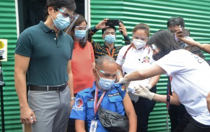 <p><strong>VAX ROLLOUT.</strong> A Metropolitan Manila Development Authority field employee receives the Covid-19 vaccine at the agency’s main office in Guadalupe, Makati City on April 14, 2021. National Task Force Against Covid-19 Chief Implementer Secretary Carlito Galvez Jr. reiterated that vaccines are free from the government while private companies which secured supplies under tripartite agreements cannot sell jabs. <em>(PNA photo by Avito C. Dalan)</em></p>