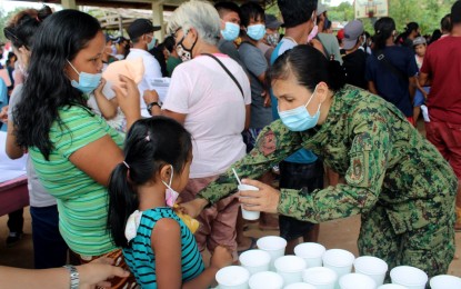 <p><strong>COMMUNITY SERVICE.</strong> Members of the Camarines Norte Police Provincial Office provide various services in Barangay Dumagmang in Labo town on April 13, 2021. Five police officers died in an ambush in the area on March 19, reportedly carried out by members of the New People’s Army. <em>(Photo courtesy of Camarines Norte PPO)</em></p>