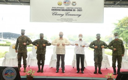 <p><strong>STANDING TOGETHER.</strong> Philippine and US military and government officials stand shoulder-to-shoulder at the closing ceremony of the 2021 Balikatan exercises in Camp Aguinaldo, Quezon City on Friday (April 23, 2021). Defense Secretary Delfin Lorenzana said learning to work together in times of disaster and crisis is the most significant lesson American and Filipino troops can learn from the annual drills. <em>(Photo courtesy of AFP Public Affairs Office)</em></p>