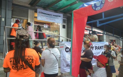 <p><strong>ANGEL’S PANTRY.</strong> Some of the lucky few who managed to reach the community pantry of actress Angel Locsin on Friday (April 23, 2021) wait for their turn to get free items. Locsin said it will be her first and last venture after a senior citizen who lined up for hours collapsed and died. <em>(PNA photo by Robert Oswald P. Alfiler)</em></p>