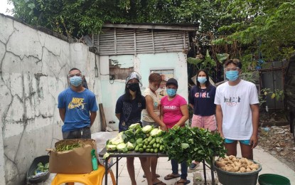 <p><strong>HEALTHY PANTRY.</strong> A group of friends offers free vegetables at a community pantry in Barangay West Crame, San Juan City on Monday (April 26, 2021). The organizers said they accept all kinds of donations. <em>(Contributed photo)</em></p>