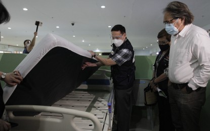 <p><strong>WALK-THROUGH.</strong> Health Secretary Francisco Duque III leads the opening and walk-through of the Eva Macapagal Isolation Facility at the South Harbor in Port Area, Manila on Monday (April 26, 2021). The facility will cater to asymptomatic Covid-19 patients and those with mild and moderate symptoms. <em>(PNA photo by Avito Dalan)</em></p>