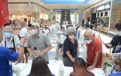<p><strong>MALL JABS.</strong> Malls are being used as vaccination centers, like in this undated photo taken in the National Capital Region. The Pasay City government has partnered with retail giant SM Supermalls to open a giga hub at the Mall of Asia where all Filipinos regardless of residence will be accommodated. <em>(PNA file photo)</em></p>