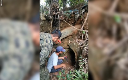 <p><strong>BOMB-MAKING FACTORY</strong>. A surrenderer shows to a soldier the tunnel used for making bombs by the New People's Army on the outskirts of Ormoc City on Monday (April 26). The military also recovered bomb-making materials and improvised explosive devices (IED). <em>(Photo courtesy of Philippine Army)</em></p>
