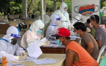 <p><strong>TESTING BOOTH</strong>. Health workers conduct mass swab testing following the surge of residents infected with coronavirus disease 2019 (Covid-19) in Dingras, Ilocos Norte. As of April 27, Dingras town has 74 active Covid-19 cases. (<em>Photo courtesy of Dingras Rural Health Unit</em>) </p>