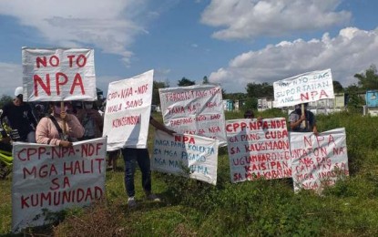 <p><strong>CONDEMNATION</strong>. Placards calling for a stop to the killings, harassments, extortion, and deception of the Communist Party of the Philippines-New People’s Army are carried by residents of E.B. Magalona, Negros Occidental, who attended the burial of Barangay Consing watchman Elmer Ortencio in Victorias City on April 25, 2021. Ortencio was abducted and killed by communist terrorists on April 13, the same day they torched about PHP17 million worth of heavy equipment being used for quarry operations. <em>(Photo courtesy of 79th Infantry Battalion, Philippine Army)</em></p>