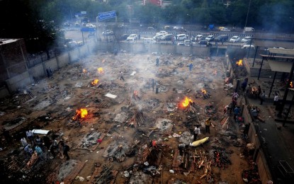 <p><strong>BACK TO ASHES.</strong> Burning funeral pyres are seen during a mass cremation for those who died from the Covid-19 at a crematorium in Delhi, India, on April 26, 2021. The coronavirus is wreaking havoc in India, accounting for 38 percent of all new Covid-19 cases recorded worldwide in the seven-day period that ended on April 25.<em> (Photo by Partha Sarkar/Xinhua)</em></p>