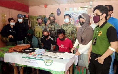 <p><strong>BUSTED.</strong> A team of Philippine Marines, the Philippine Drug Enforcement Agency, and intelligence units arrest three suspected big-time drug personalities (seated) in an anti-drug operation Wednesday (April 28, 2021) in Barangay Pag-asa, Bongao, Tawi-Tawi. Charges for violation of the Comprehensive Dangerous Drugs act of 2002 will be filed against the suspects. <em>(Photo courtesy of Western Mindanao Command Public Information Office)</em></p>