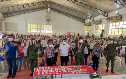 <p><strong>NEW LIFE.</strong> Officials of the provincial government of Bulacan and law enforcement agencies lead the withdrawal of support of some 200 members of the Kalipunan ng Damayang Mahihirap (Kadamay) and Bayan Muna from the communist movement in a ceremony in Barangay Poblacion 1, San Jose del Monte City on Friday (April 30, 2021). The former members of Kadamay and Bayan Muna in the city are now eligible for the government’s Enhanced Comprehensive Local Integration Program for rebel returnees. <em>(Photo courtesy of Bulacan PPO)</em></p>