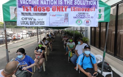 <p><strong>CHOSEN FEW.</strong> Overseas workers and minimum wage workers line up for a symbolic vaccination activity at the Palacio de Maynila in Malate, Manila on Saturday (May 1, 2021). The country aims to vaccinate at least 50 percent of the adult population within the year as long as supplies will allow, according to testing czar Vince Dizon. <em>(PNA photo by Joey Razon)</em></p>