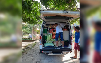 <p><strong>DELIVERY.</strong> A member of Inabaan Norte Agricultural Multi-Purpose Cooperative in La Union province unloads vegetables and other crops from a van during delivery of goods to the Ilocos Training and Regional Medical Center in December 2020. The partnership of the agrarian reform beneficiary organization and the Department of Health hospital is under the Enhanced Partnership Against Hunger and Poverty (EPAHP) project. <em>(Photo courtesy of Inabaan Norte Agricultural MPC's Facebook page).</em></p>