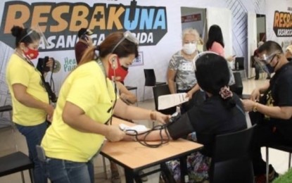 <p><strong>VACCINATION FOR ELDERLIES</strong>. Health workers take the vital signs of elderlies who are getting vaccine jabs at three different locations in Cebu City. Vaccination for the senior citizens resumed on Monday (May 3, 2021) after the city received 10,000 doses out of 56,000 doses of CoronaVac vaccines intended for Central Visayas last Friday. <em>(Photo courtesy of Cebu City Hall PIO)</em></p>
