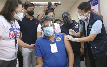 <p><strong>SPUTNIK V VACCINATION.</strong> Health Secretary Francisco Duque III injects Sta. Ana Hospital senior administrative assistant Walther Rigonan with the Russian-made Sputnik V vaccine on Tuesday (May 4, 2021). Duque said after the initial 15,000 doses, 485,000 more will arrive within May.<em> (Photo by Joey Razon)</em></p>