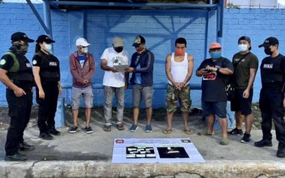 <p><strong>BUY-BUST</strong>. Operatives from the Philippine Drug Enforcement Agency (PDEA)-Central Visayas and the Lapu-Lapu City Police Office Intelligence Unit conduct an inventory of confiscated illegal drugs worth PHP1.3 million after a sting operation on Tuesday (May 4, 2021). The suspect, Ronie Dadula Cuizon, of Barangay Labangon, Cebu City (fourth from right) is watch-listed as a high-value target in Central Visayas.<em> (Photo courtesy of PDEA Regional Director Levi Ortiz)</em></p>
