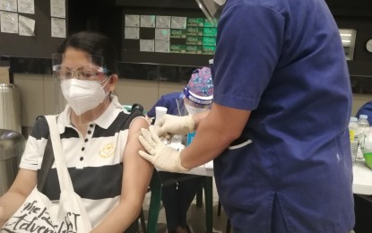 <p><strong>SPUTNIK V ROLLOUT</strong>. A Parañaque City resident receives the Russian-made Sputnik V jab on Tuesday (May 4, 2021) at Ayala Malls Manila Bay. Parañaque is one of five cities in Metro Manila given 3,000 doses for the pilot rollout. <em>(PNA photo by Lade Kabagai)</em></p>