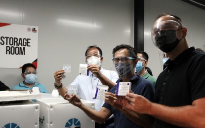 <p><strong>READY TO HANDLE</strong>. Vaccine czar Carlito Galvez Jr. alongside testing czar Vince Dizon and Mayor Lino Cayetano check Taguig City's vaccine cold storage room for Russian-made Sputnik V jabs produced by Gamaleya Research Institute on Wednesday (May 5, 2021). Galvez says Taguig City is ready to handle highly-sensitive Covid-19 vaccines that require sub-zero temperatures such as Sputnik V, Pfizer, and Moderna. <em>(PNA photo by Jess M. Escaros Jr.)</em></p>