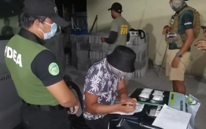 <p><strong>DRUG HAUL</strong>. An agent of the Philippine Drug Enforcement Agency-Western Visayas Regional Special Enforcement Team conducts an inventory of the PHP3.4 million worth of suspected shabu seized during a buy-bust in Murcia, Negros Occidental on Tuesday (May 4, 2021). One of the three suspects evaded arrest. <em>(Photo courtesy of PDEA-Western Visayas)</em></p>