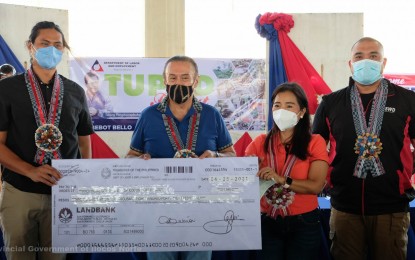 <p><strong>FINANCIAL GRANT</strong>. The provincial government of Ilocos Norte represented by provincial administrator, Atty. Pancho Jose (left) receives a check worth PHP991,848 on Thursday (May 6, 2021) in a ceremony held at the Laoag City Terminal. Also in photo (L-R) are Laoag City Mayor Michael Keon, DOLE Regional Director Evelyn Ramos, and DSWD Assistant Secretary Victor Neri. (<em>Photo courtesy of Ilocos Norte province</em>) </p>